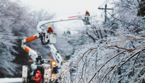Electric Company crew working on a frozen powerline pole
